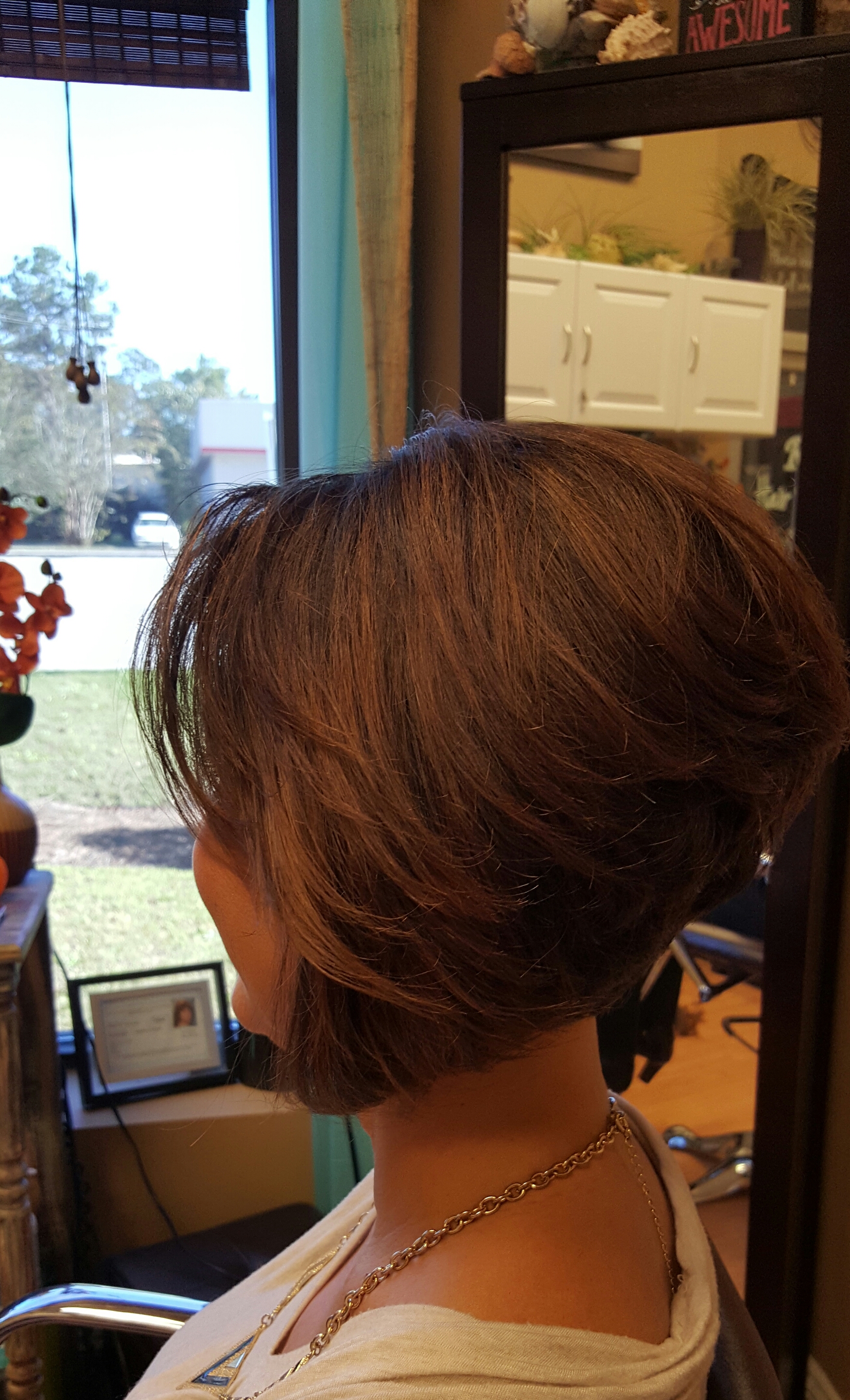 A stacked, layered bob in rich brown, styled by Robin